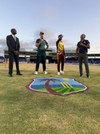 west indies and australian cricket captains standing on the ground for pre-match toss